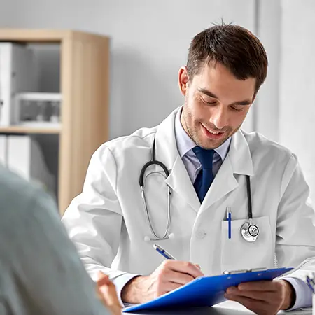 Doctor at practice busy signing in a new patient