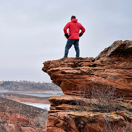 Man climbing boulder and rocks at Horsetooth park outside of Fort Collins